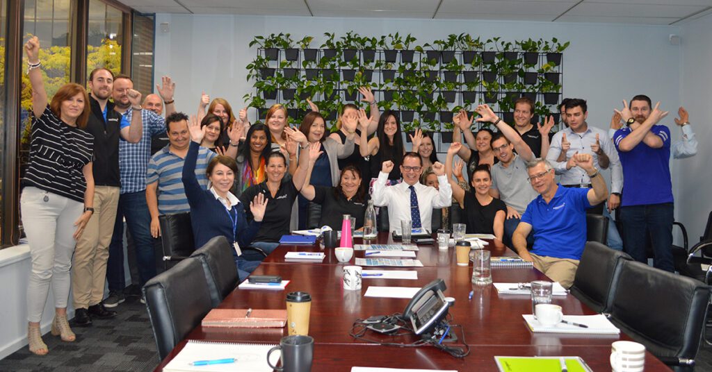 Positive and fun strengths-based team building workshop with colleagues engaging, collaborating, and building stronger workplace connections.